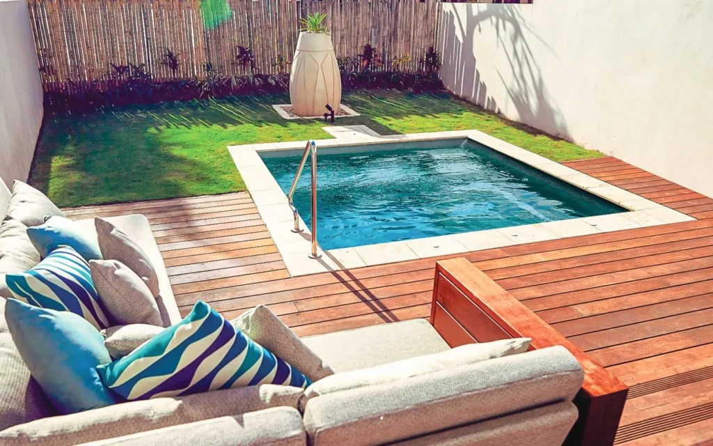Leisure Fiji Plunge set into a timber deck with a stainless handrail
